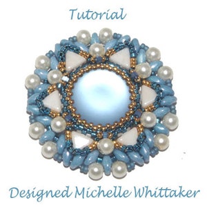 May include: A blue and white beaded flower with a light blue center and gold accents. The flower is surrounded by white pearls. The image includes the text "Tutorial" and "Designed Michelle Whittaker".