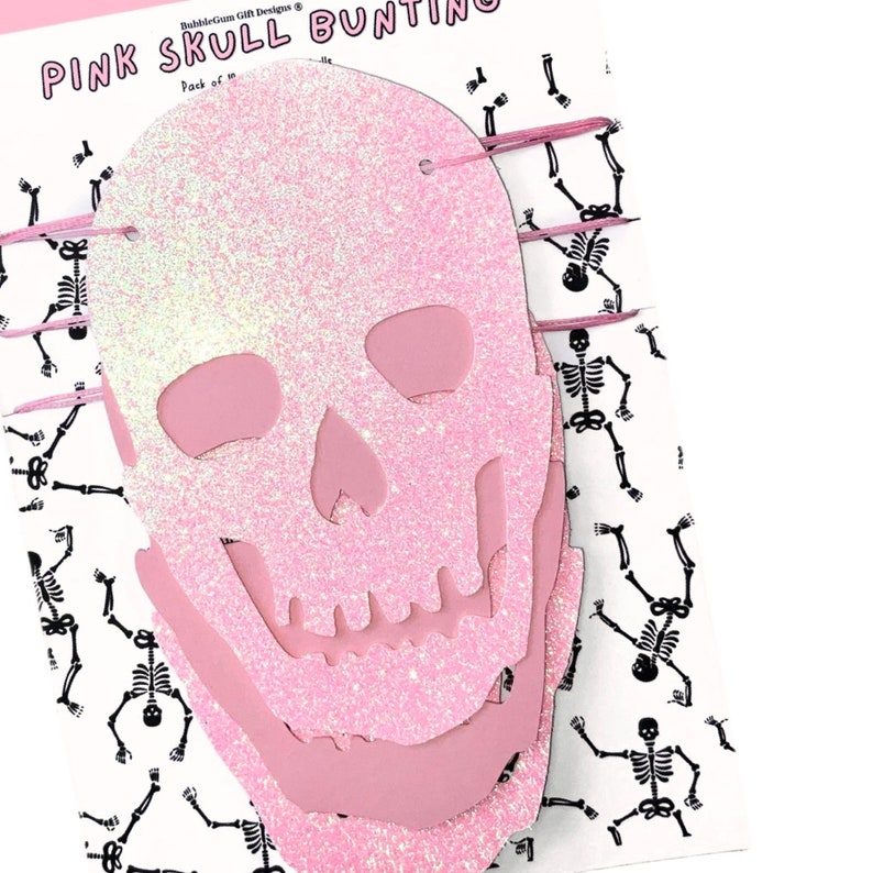 May include: Pink glitter skull bunting with a white background featuring a repeating pattern of black skeletons. The text "PINK SKULL BUNTING" is at the top of the image.