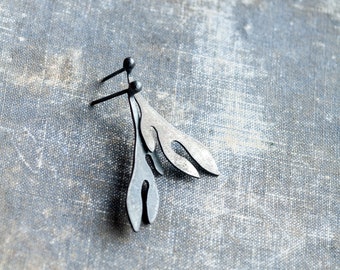 May include: A pair of silver earrings with a leaf design. The earrings are made of metal and have a simple, elegant look.