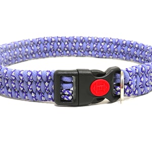 May include: A purple and white braided dog collar with a black plastic buckle and a silver D-ring.