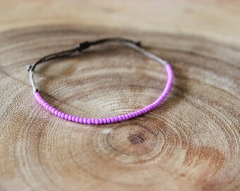 Macrame bracelet with brass cat charm and glass rainbow tube and seed beads and square light pink glass beads