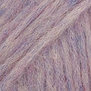May include: Close-up of a skein of yarn in shades of lavender, light purple, and blue. The yarn appears soft and fluffy, with a slightly textured appearance. The fibers are loosely spun, creating a delicate and airy look, ideal for knitting or crocheting projects.