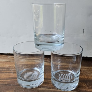 May include: Three clear glass tumblers, two with a white logo that says "Union Pacific" with black stripes.