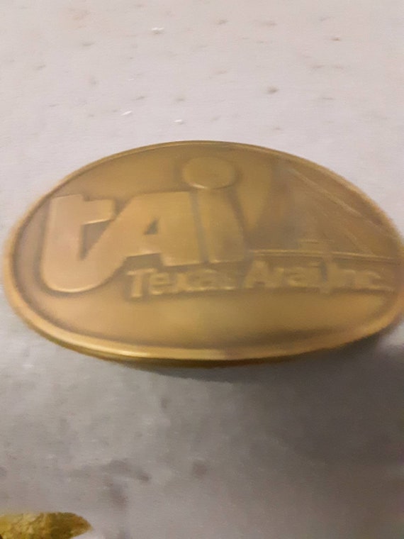 Brass Belt Buckle TAI Texas Arai. Inc. Advertising