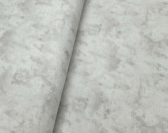 May include: A close-up of a light gray fabric with a subtle, textured pattern that resembles concrete.