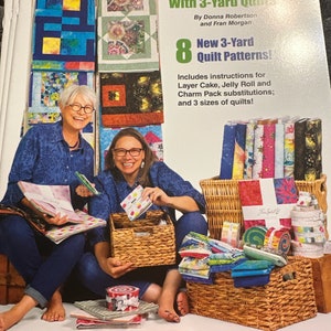 May include: A book titled "Stash Busting with 3-Yard Quilts" by Donna Robertson and Fran Morgan. The book cover features two women sitting with fabric scraps and baskets. The book includes 8 new 3-yard quilt patterns and instructions for layer cake, jelly roll, and charm pack substitutions.