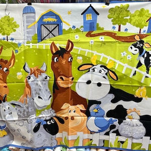 May include: A colorful fabric panel with a farm theme. It features a brown horse, a gray horse, a black and white cow, a brown donkey, a pig, a blue bird, and two chicks. The panel also has a red barn, a blue house, and a green field.