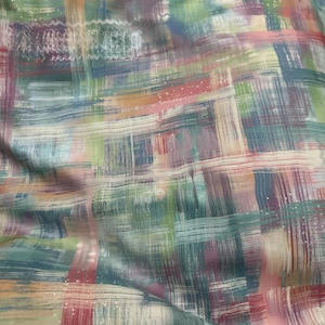 May include: Abstract fabric with a painterly design. The fabric features a blend of colors including teal, pink, purple, orange, and green. The design is created with brushstrokes, giving it a textured appearance. The fabric is likely used for clothing or home decor.