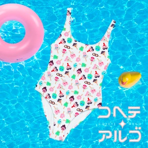 May include: A white swimsuit with a colorful pattern of ice cream cones and faces. The swimsuit is floating in a blue pool with a pink inflatable ring and a yellow rubber duck.