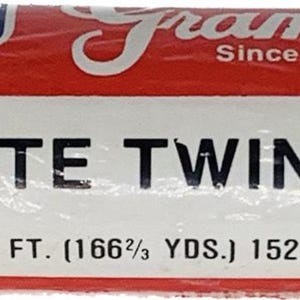 May include: A roll of white kite twine, wrapped in clear plastic. The label reads "KITE TWINE" and "500 FT. (166⅔ YDS.) 152.4m". The ends of the roll have a barber pole design with red, white, and blue stripes. The brand name "Framco" is also visible.