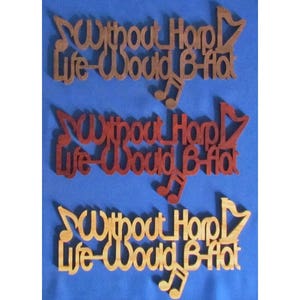 May include: Three wooden signs with the text "Without Harp Life-Would B-flat" in different wood stains. The signs are brown, red, and light brown.