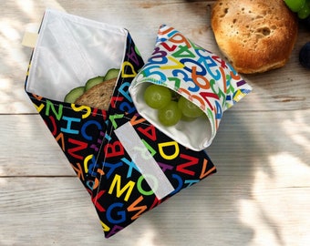 lunch bag for children, eco friendly sandwich wrap, reusable snack bag, practical stocking filler for kids, black waterproof food wrap