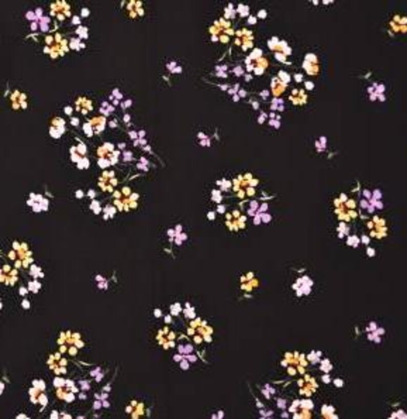May include: Black fabric with a small floral pattern in shades of purple, yellow, and white.