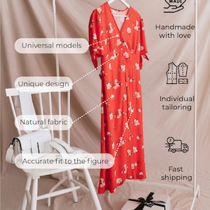 May include: A red floral dress with a V-neckline and short sleeves hangs on a white clothing rack. The dress is handmade with love and features a unique design, natural fabric, and an accurate fit to the figure. The image also includes a white chair, a white purse, and a white gift box with a black ribbon.