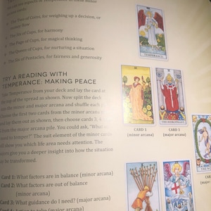 May include: A page from a book titled Temperance's Reflections, featuring text instructions for a tarot card reading spread. The page displays illustrations of several tarot cards, including Temperance, The Hierophant, The World, and Judgement.