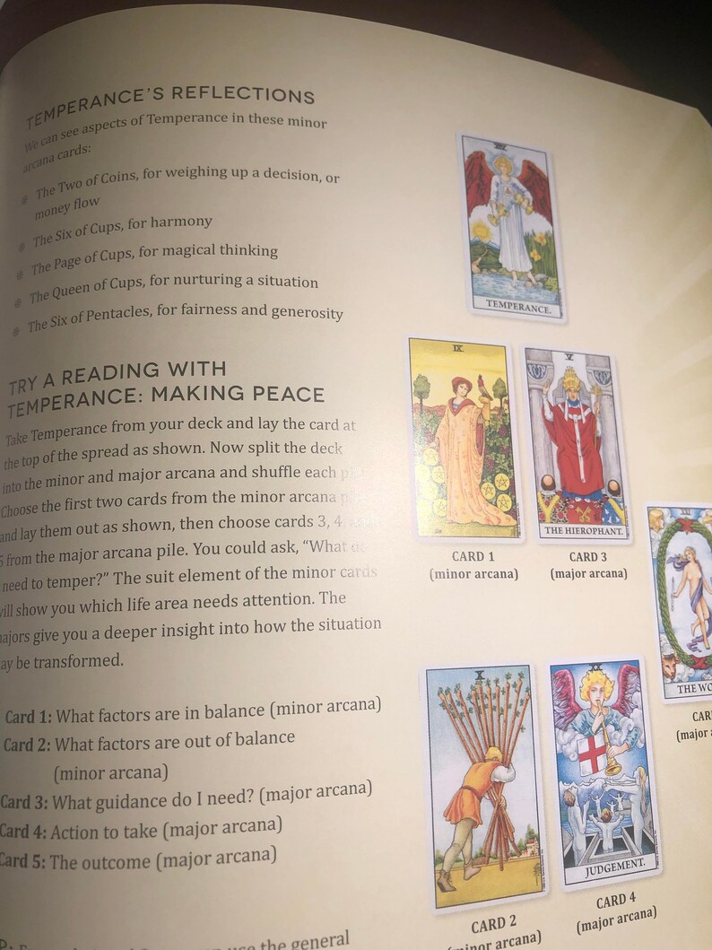 May include: A page from a book titled Temperance's Reflections, featuring text instructions for a tarot card reading spread. The page displays illustrations of several tarot cards, including Temperance, The Hierophant, The World, and Judgement.