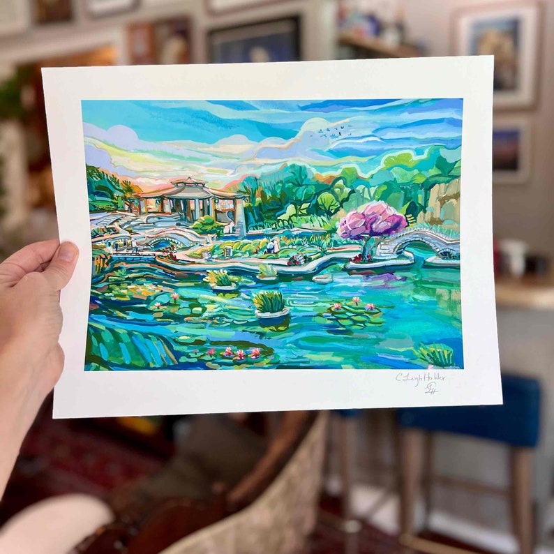 May include: A colorful painting of a Japanese garden with a pond, bridge, and a small pagoda. The painting is done in a vibrant style with bright colors and bold strokes. The artist's signature is in the bottom right corner.