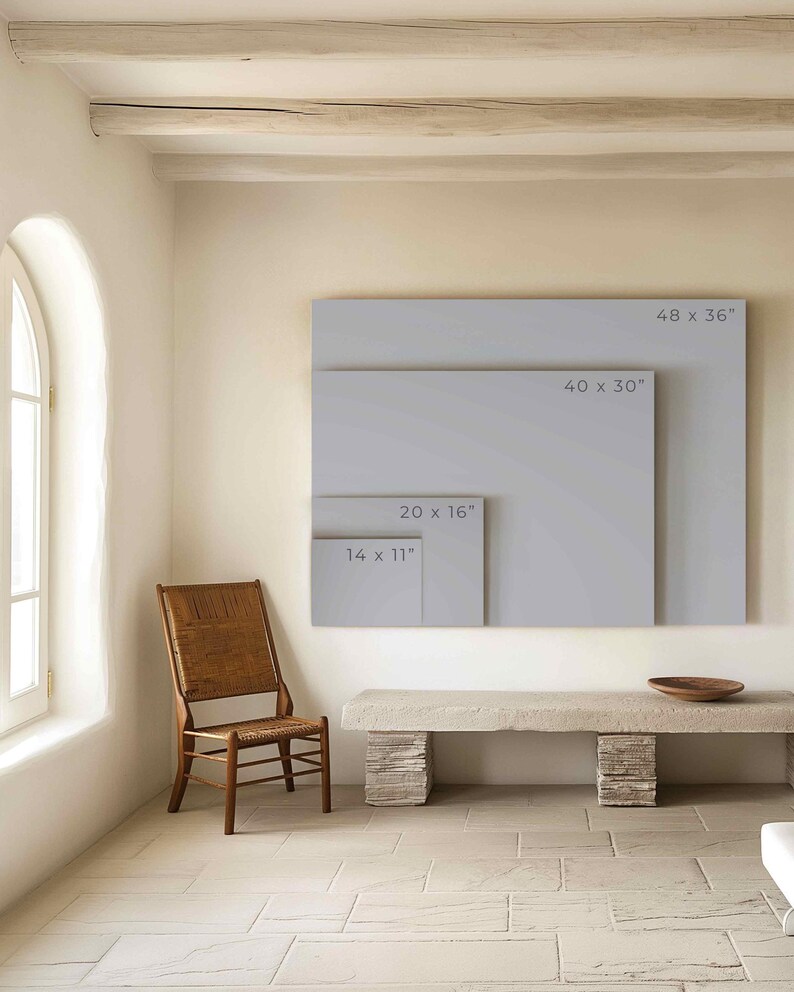 May include: A white wall with four different sized frames, each with a different measurement listed in inches. The frames are all empty and are hanging on the wall. A wooden chair and a stone bench are in the foreground.