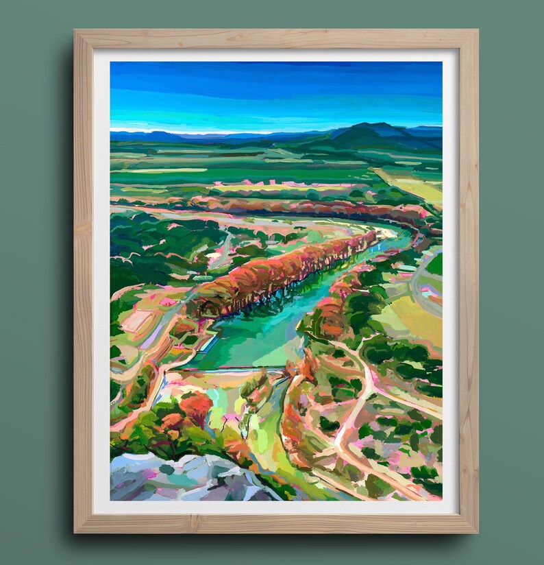 May include: A colorful painting of a river winding through a green valley. The river is surrounded by trees, some of which are red and orange. The painting is done in a loose, impressionistic style.