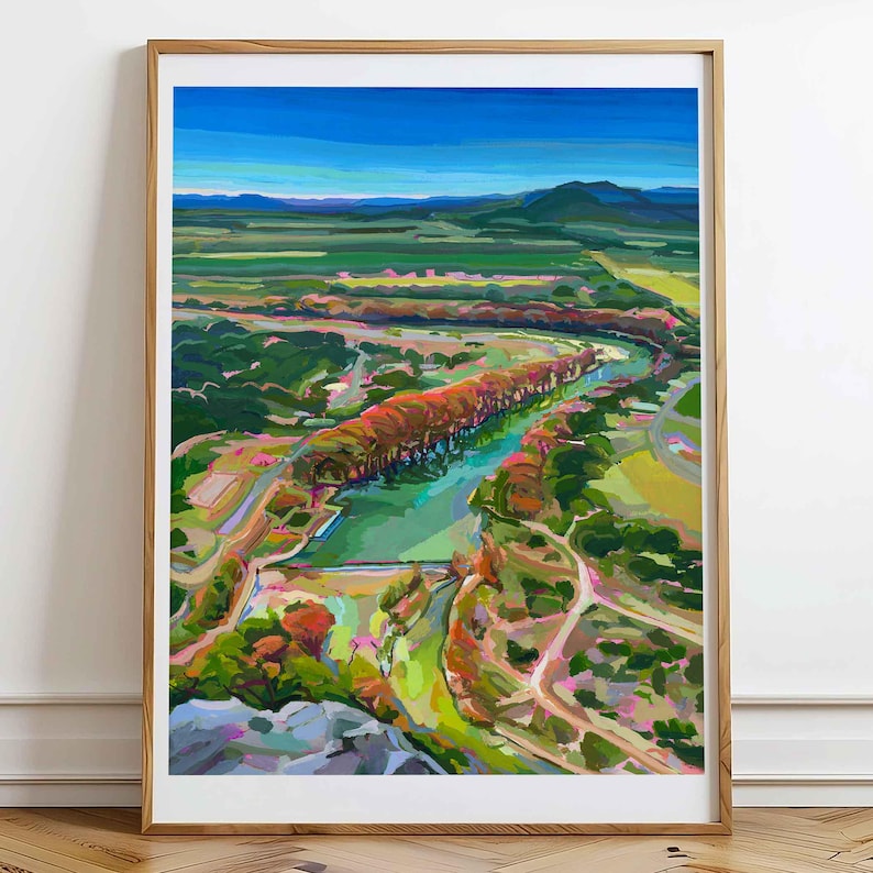 May include: A colorful abstract painting of a river winding through a valley. The river is a bright turquoise blue and the valley is a mix of greens, yellows, and oranges. The painting has a painterly style with visible brushstrokes.