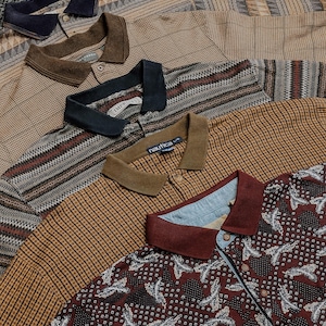 May include: A collection of five polo shirts layered together, featuring various patterns including geometric, plaid, and floral designs in shades of brown, tan, navy, and burgundy, each with a collared neckline and button-front placket.