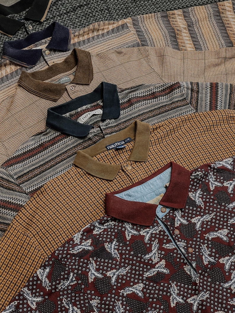 May include: A collection of five polo shirts layered together, featuring various patterns including geometric, plaid, and floral designs in shades of brown, tan, navy, and burgundy, each with a collared neckline and button-front placket.