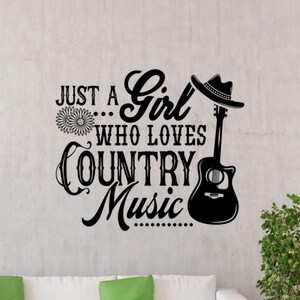 May include: Black and white vinyl wall decal with the text "Just a Girl Who Loves Country Music" and a silhouette of a guitar with a cowboy hat on top.