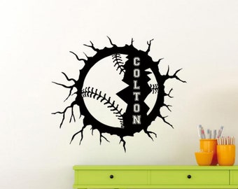 May include: Black and white baseball wall decal with the name Colton written vertically inside the baseball. The baseball is cracked and broken, with the cracks extending out in a jagged pattern.