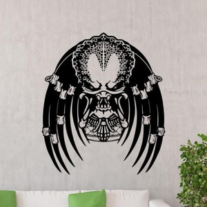 May include: Black and white Predator head silhouette wall decal. The Predator is a fictional alien species known for its hunting skills and advanced technology.
