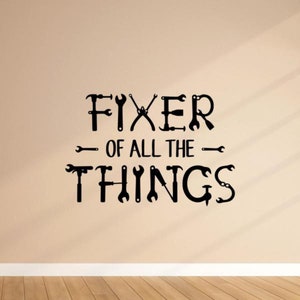 May include: Black and white wall decal with the text "Fixer of all the things" with various tools forming the letters.