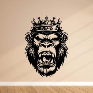 May include: A black and white illustration of a gorilla's head wearing a crown. The gorilla has an open mouth, revealing its teeth. The image is a bold graphic design, suitable for wall art or apparel.