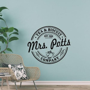 May include: Black and white decal of a teacup with a face and the text "Mrs. Potts Tea & Biscuit Company Est. 1991" in a circle.