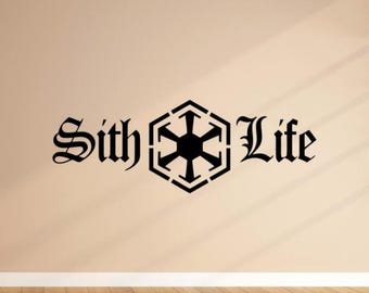 May include: Black "Sith Life" wall decal. The text is in a gothic font, with a geometric symbol in the center. The decal is on a beige wall with a wooden floor.