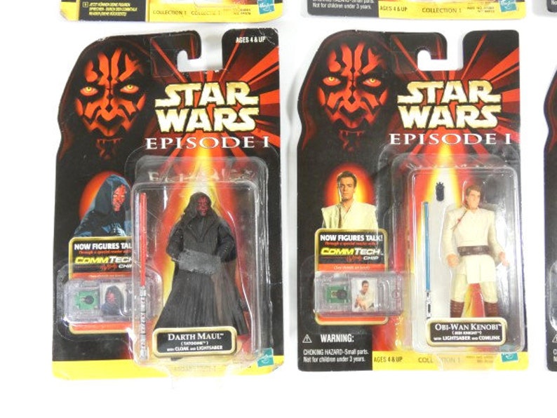 May include: Two Star Wars Episode I action figures in their original packaging. The figures are Darth Maul and Obi-Wan Kenobi. The packaging features the Star Wars logo and the words "Now figures talk! CommTech Chip".