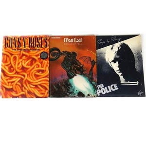 May include: Three vinyl record album covers. The first is Guns N' Roses "The Spaghetti Incident!" with a close-up of spaghetti and tomato sauce. The second is Meat Loaf "Bat Out Of Hell" with a motorcycle and a demon. The third is "Songs by Sting" with a black and white photo of Sting with the text "The Police".