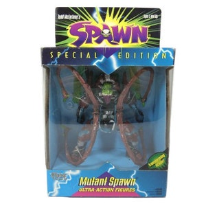 May include: A green and red Spawn action figure in a plastic package. The figure is a mutant version of Spawn with tentacles. The package is blue and white with the words "Spawn Special Edition" and "Mutant Spawn Ultra-Action Figures".