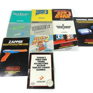 May include: A collection of 10 Nintendo Entertainment System game cartridges, including Super Mario Bros. 3, Super Mario Bros. 2, Zapper, Gun. Smoke, Bad Racer, Top Gun, Duck Hunt,  and  Control Deck.  The cartridges are arranged in a grid pattern on a white surface.