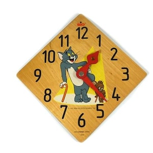 May include: A square wooden clock featuring Tom and Jerry cartoon characters. The clock face is light brown with black numerals and red clock hands. Tom is depicted in the center, with Jerry below. The clock measures approximately 8 inches by 8 inches.