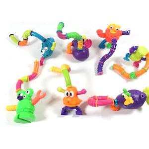 May include: A set of colorful, bendable, plastic toys that can be assembled into different creatures. The toys are made of bright colors, including green, orange, purple, yellow, and blue.