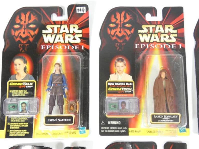 May include: Two Star Wars Episode I action figures in their original packaging. The figures are Padm&eacute; Amidala and Anakin Skywalker. The packaging features a red and black Darth Maul design with the Star Wars logo and episode title.