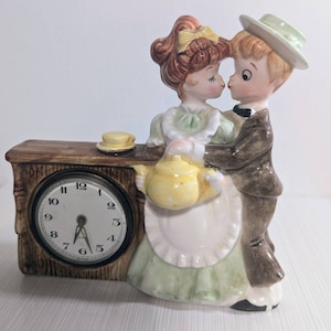 Vintage ceramic clock featuring young well dressed couple (clock broken)