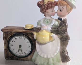Vintage ceramic clock featuring young well dressed couple (clock broken)