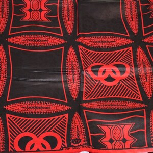 May include: Red and black fabric with a repeating pattern of interlocking circles and geometric shapes. The fabric has the text "VIP GOLD BAZIN" printed on it.