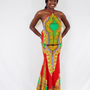 May include: A red and green patterned halter top and matching maxi skirt. The skirt has a mermaid style hem.