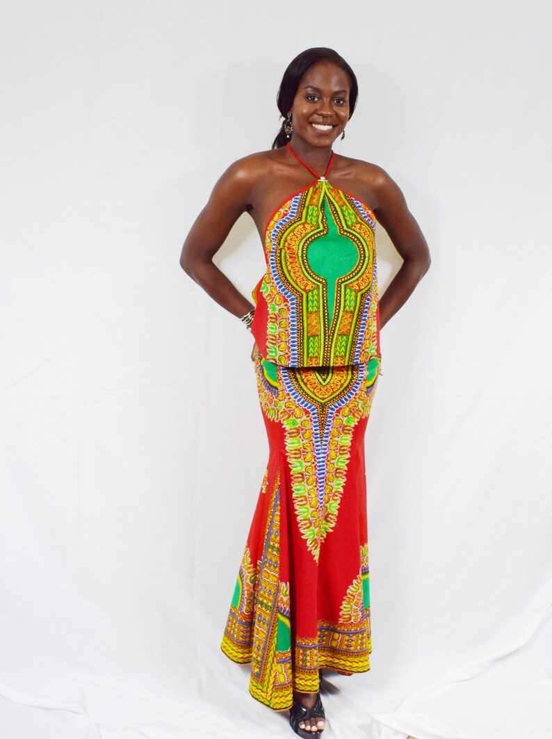 May include: A red and green patterned halter top and matching maxi skirt. The skirt has a mermaid style hem.