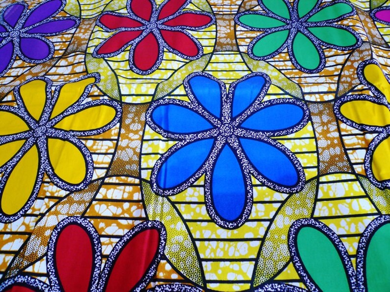 May include: A yellow fabric with a repeating pattern of colorful flowers. The flowers are outlined in black and have a white dotted pattern inside. The flowers are in shades of red, blue, green, and yellow.