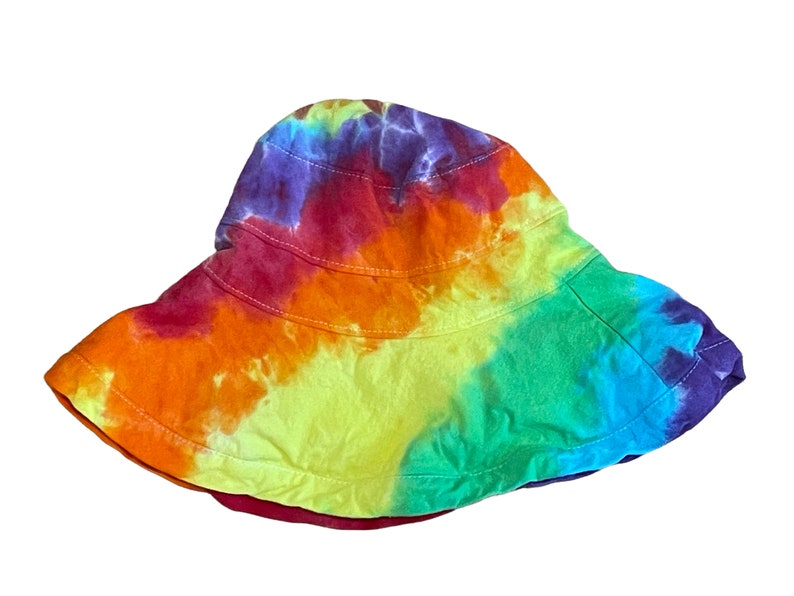 May include: A tie-dye bucket hat with a rainbow pattern in shades of red, orange, yellow, green, blue, and purple.