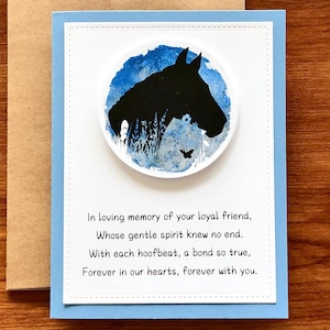 May include: A sympathy card with a blue watercolor background and a silhouette of a horse's head. The card reads "In loving memory of your loyal friend, Whose gentle spirit knew no end. With each hoofbeat, a bond so true, Forever in our hearts, forever with you."