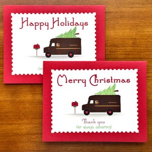 May include: Two red holiday greeting cards with white scalloped borders. One card says "Happy Holidays" and the other says "Merry Christmas." Both cards feature a brown UPS truck carrying a Christmas tree and a mailbox.
