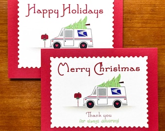 May include: Two Christmas cards with red borders and white centres. One says "Happy Holidays" and the other says "Merry Christmas." Both feature a postal truck carrying a Christmas tree. The bottom card says "Thank you for always delivering!"